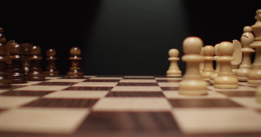 White pawn sliding on a chess board