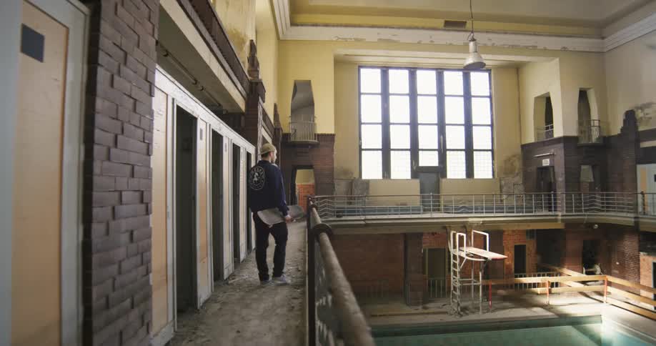 A man walks through the abandoned building
