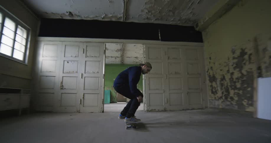 A man is skateboarding through the building