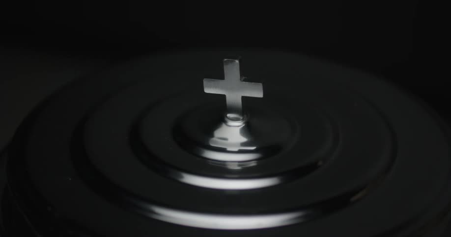 A cross glows on top of a church