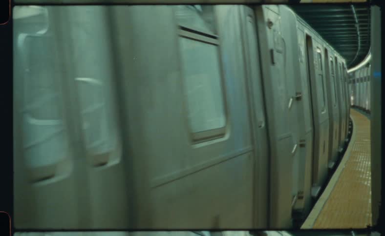 A subway is moving through a terminal