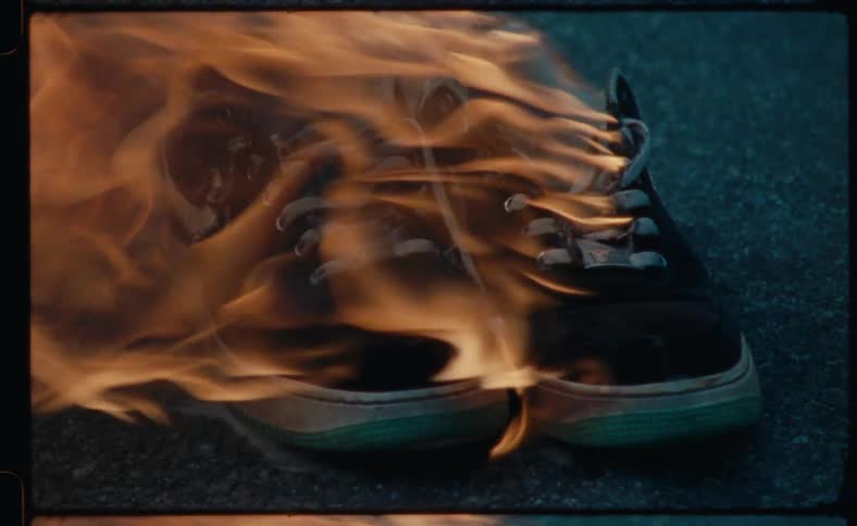 A pair of shoes burn in the street