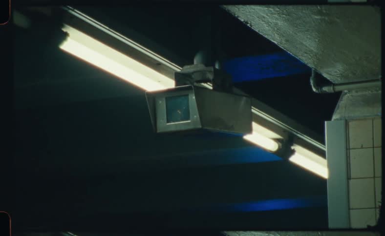 A video camera is shown in an indoors building