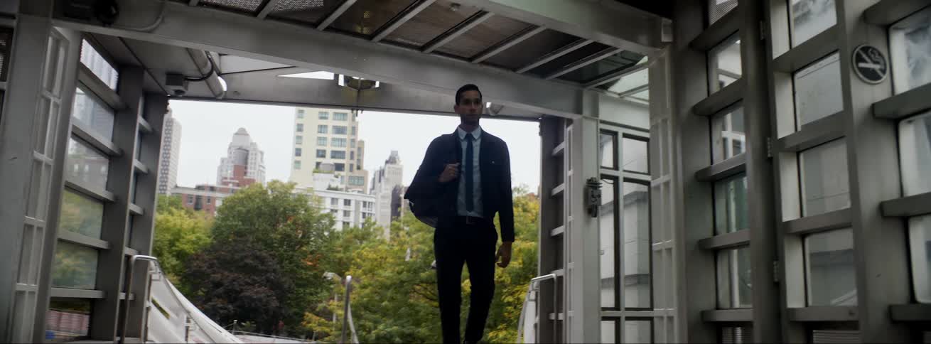 A man is jogging up some stairs in a building