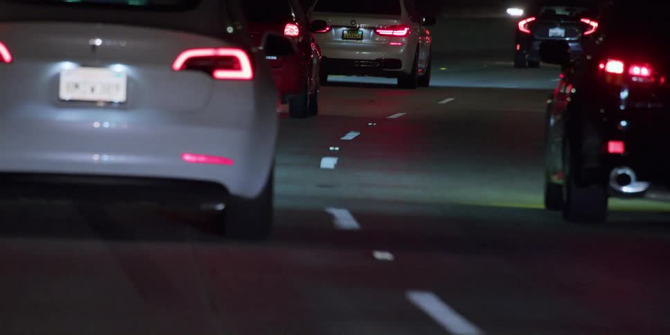 Cars in traffic on a highway at night