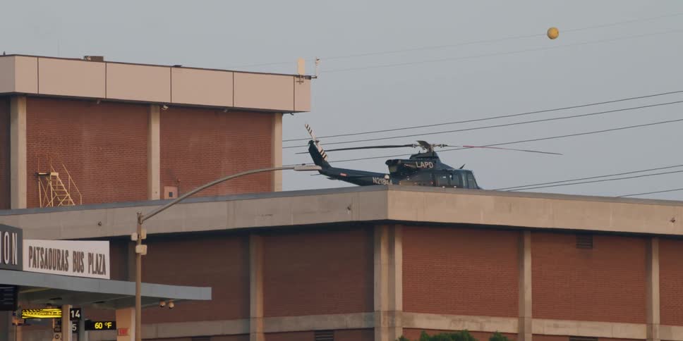 A helicopter belonging to the lapd is sitting on top of a building
