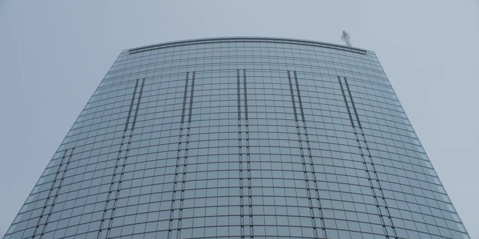 Looking up at a tall skyscraper high in the sky