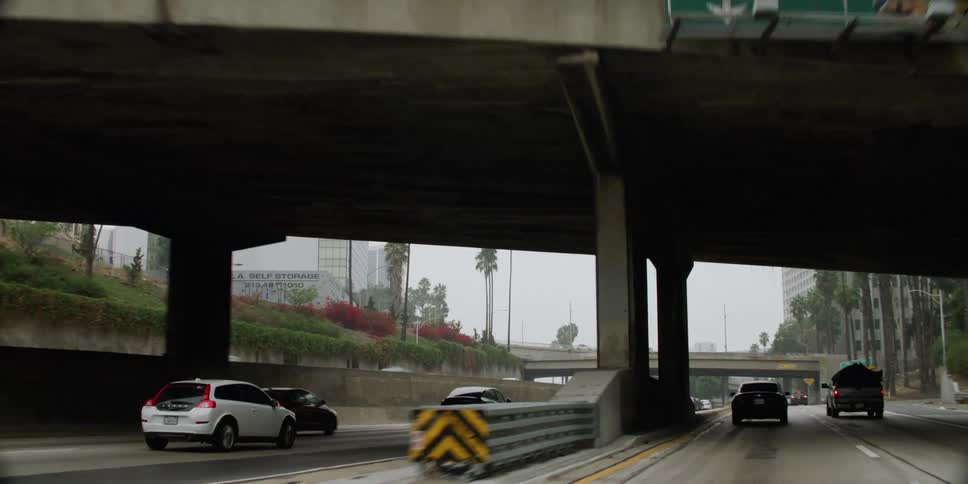 Heavy traffic passes down a highway through downtown
