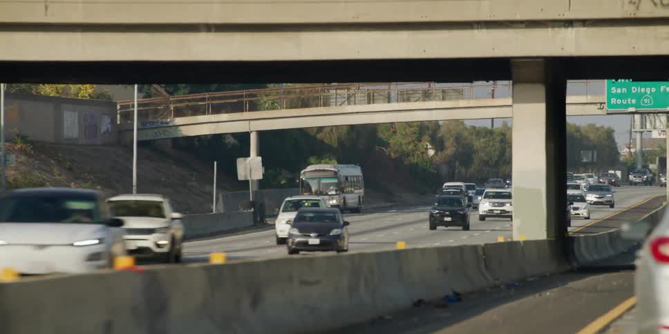 Cars and busses drive on dual carriageway