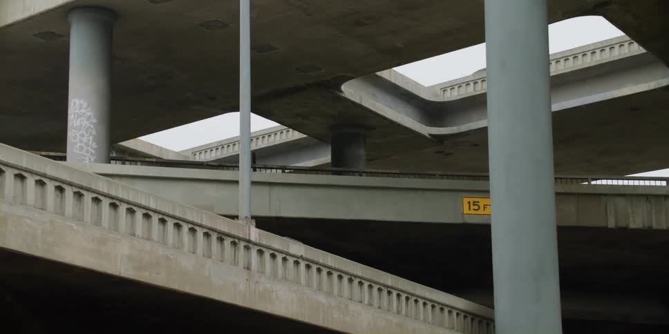 Cars are driving on a ramp in a city