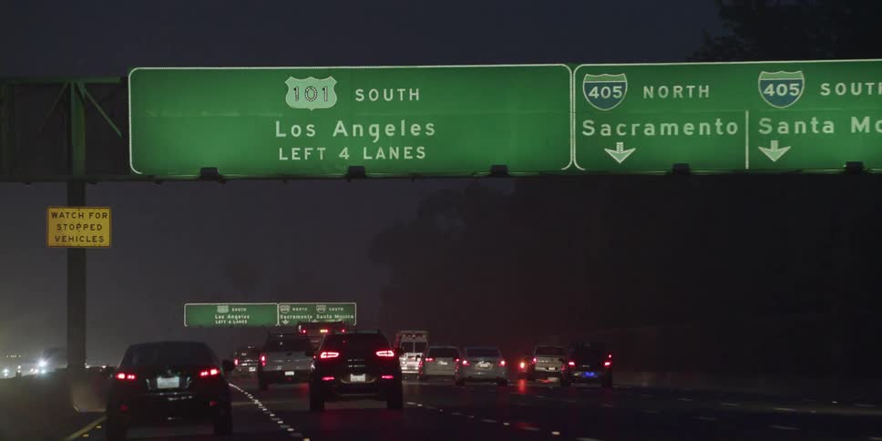 Cars driving on a freeway at night