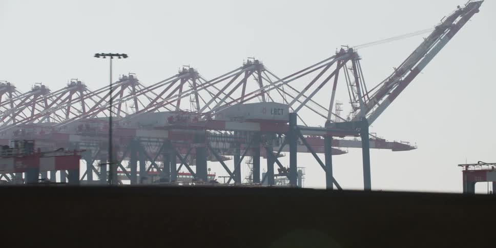 View of a large industrial plant seen from a vehicle traveling on the highway on an overcast day