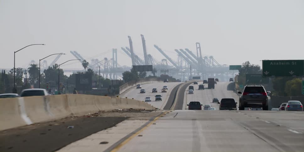 Cars are driving on a divided highway in spring