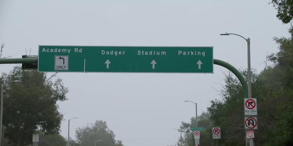 Sign above a road indicating the way to dodger stadium