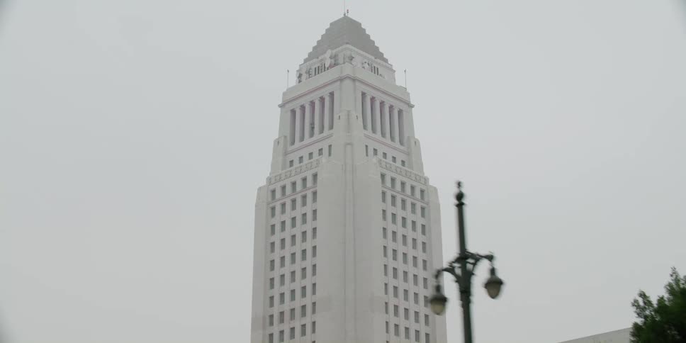 Aerial view of a building in a downtown city is displayed