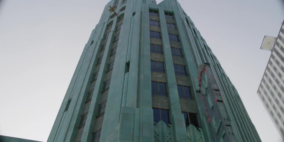 Street passes building with theater marquee