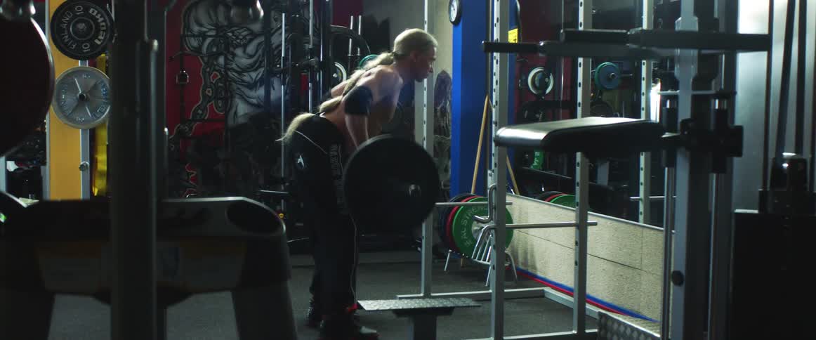 A man is working out and lifting weights indoors