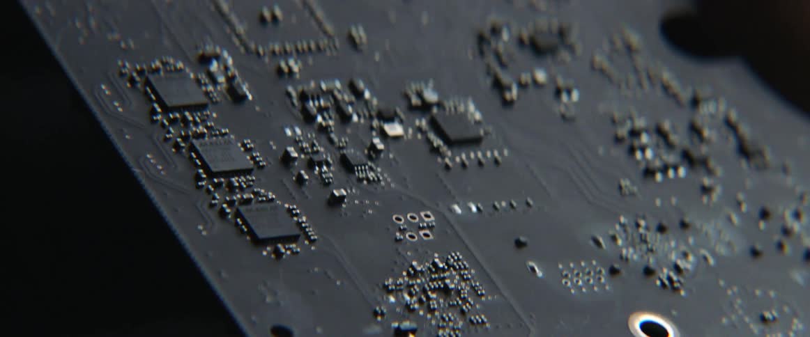 Someone is holding an electronic component in their hand