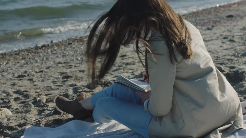 A woman writes in her notebook