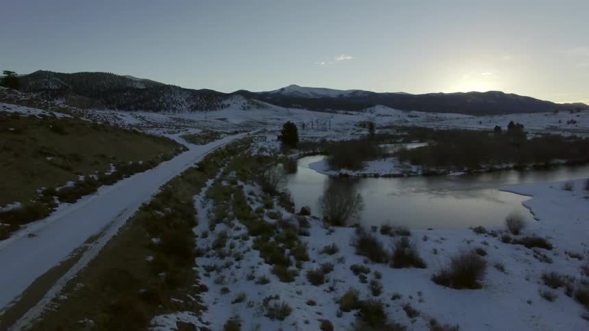 A lake surrounded by snowy land