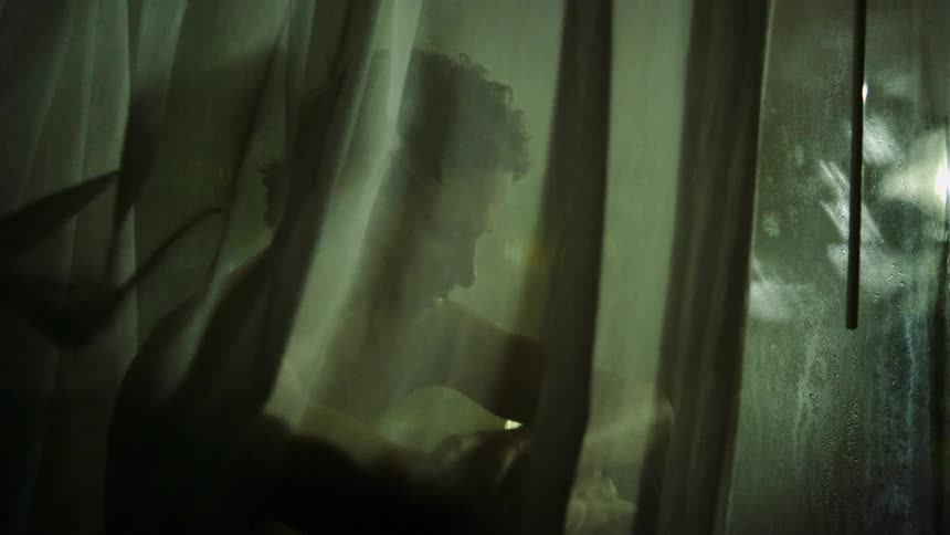 A man is sitting by the window