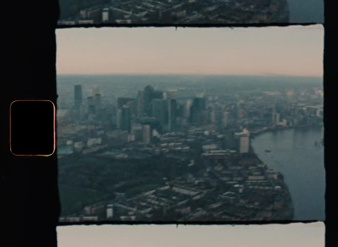 Aerial view of high rise buildings next to river at dawn