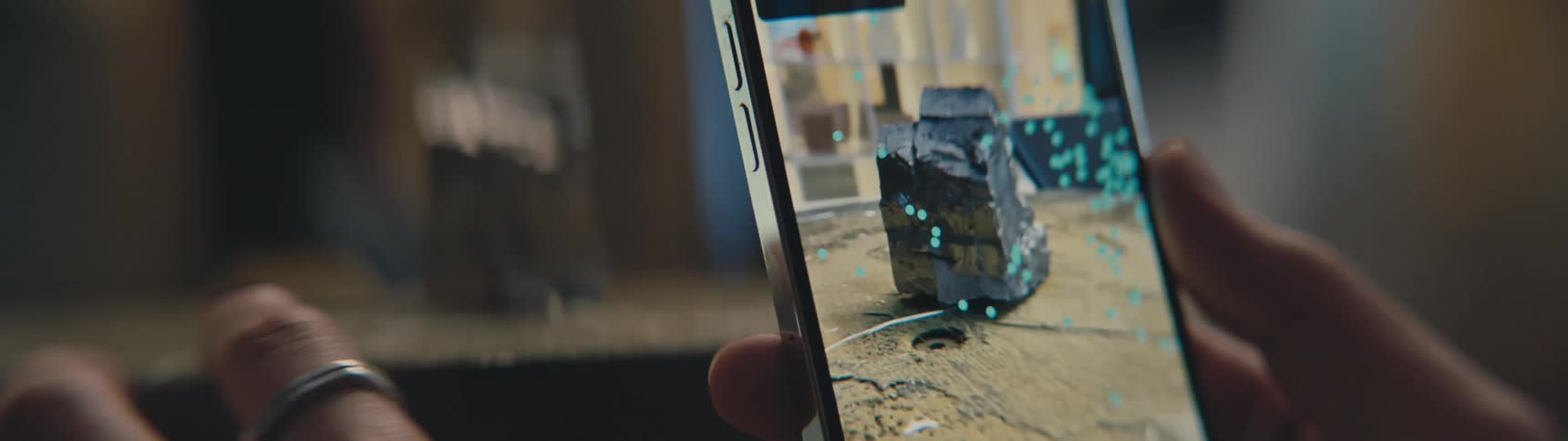 A man is filming an object with his phone
