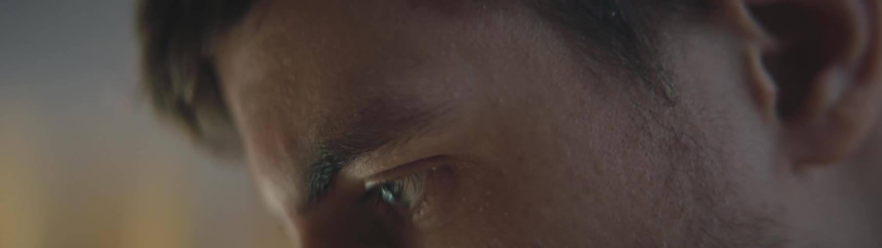 Close up of mans face working on laptop in laboratory