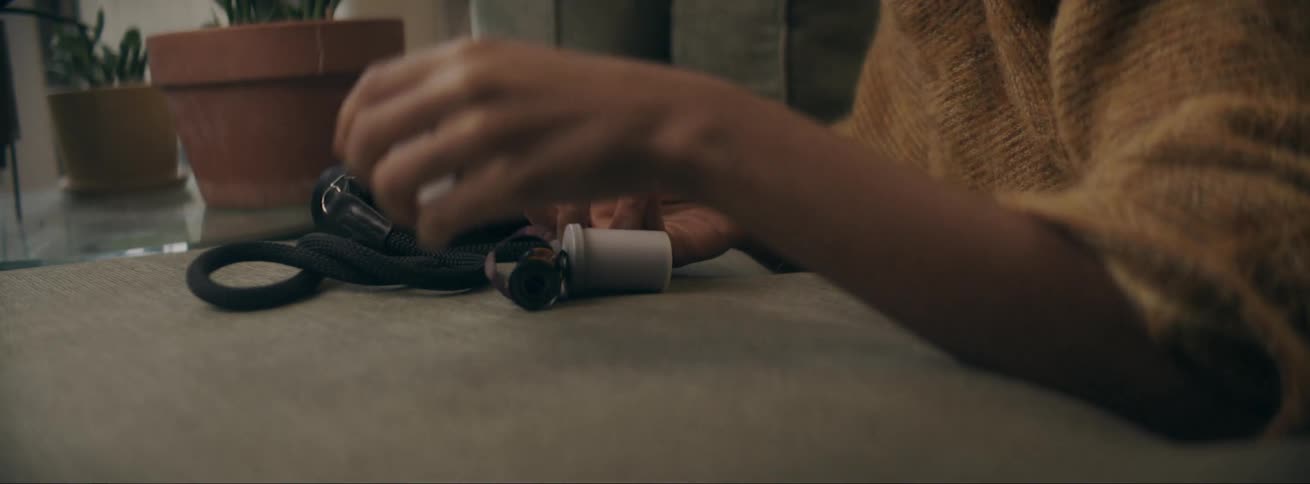 A woman takes out a camera film and gets it ready to install it in the camera