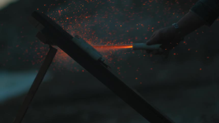 A man holds a sparking firework
