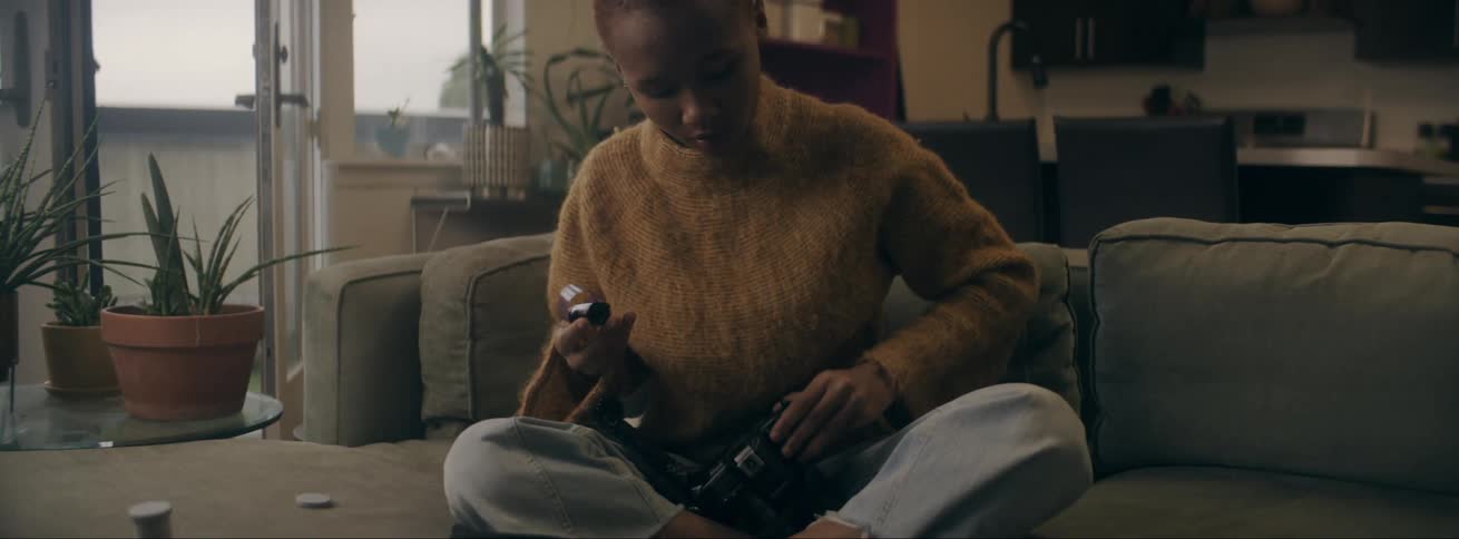 A woman loads her camera with film