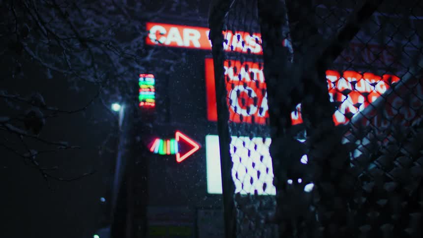 The snow is falling around the signs