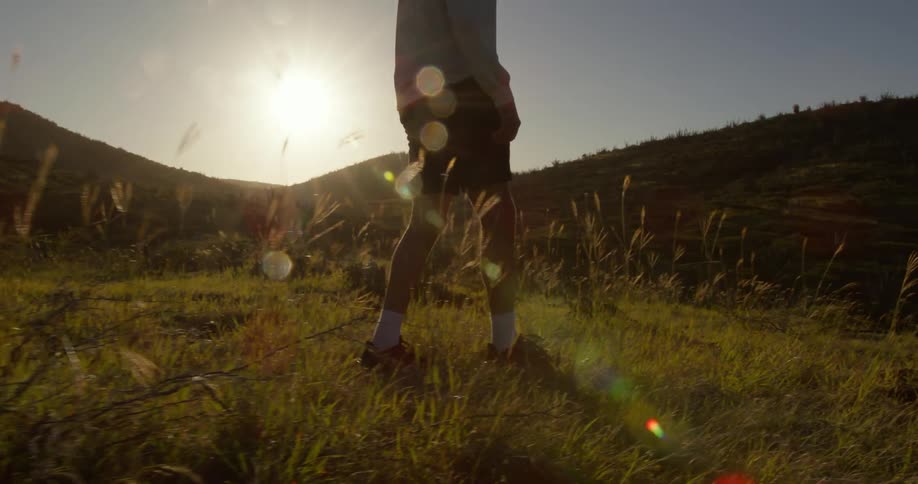 A man is hiking at sunrise