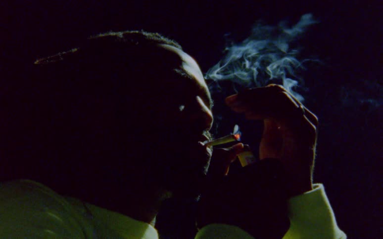 A man uses a lighter to light a cigarette