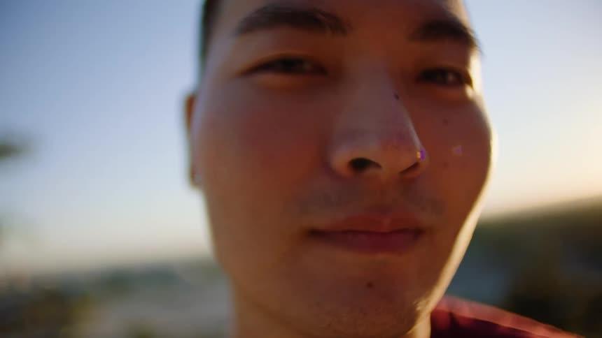 A man is smiling outside