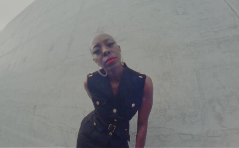A model bends and leans forward toward the camera