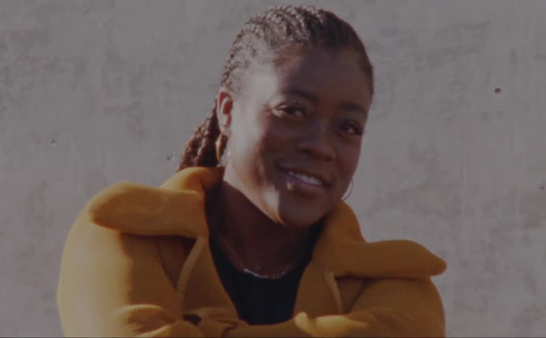A woman is posing outside