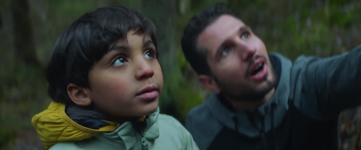 A man talks to a child outside