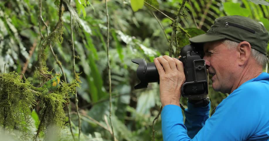 A photographer snaps some pictures in the wild