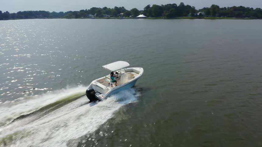 A boat travels along a lake