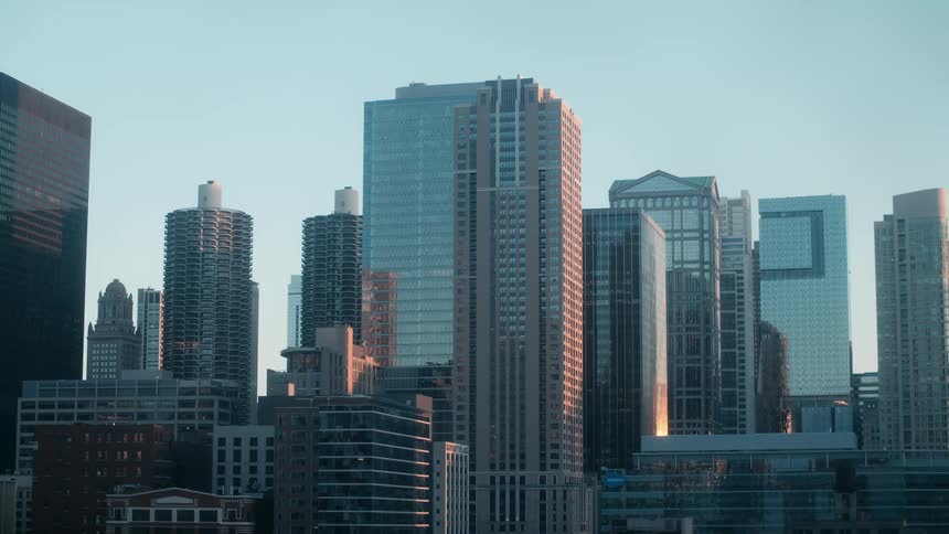 Skyscrapers with glass curtain walls in the city at sunrise