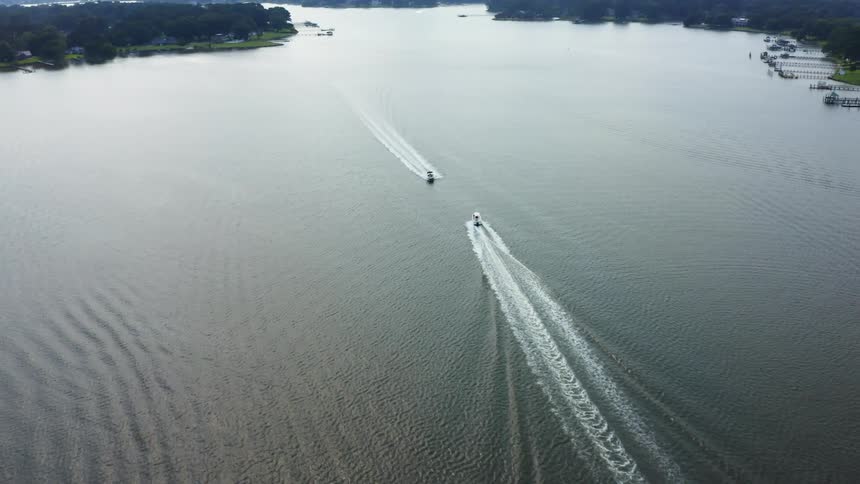 Two boats pass each other in the water