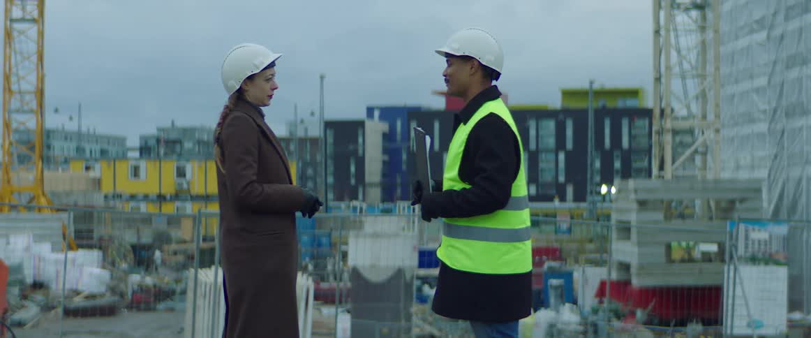 A construction worker talking wtih a client