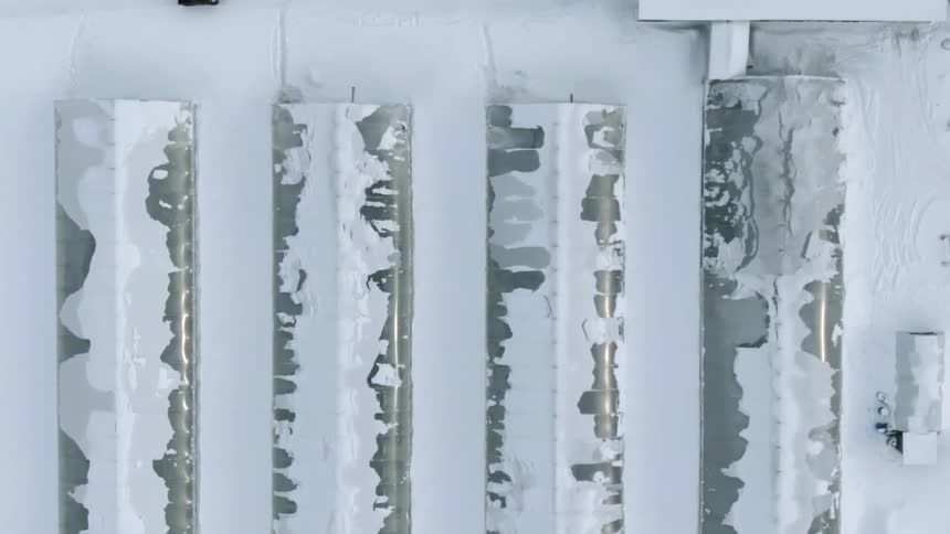 Aerial view of long snow covered buildings on a winter day