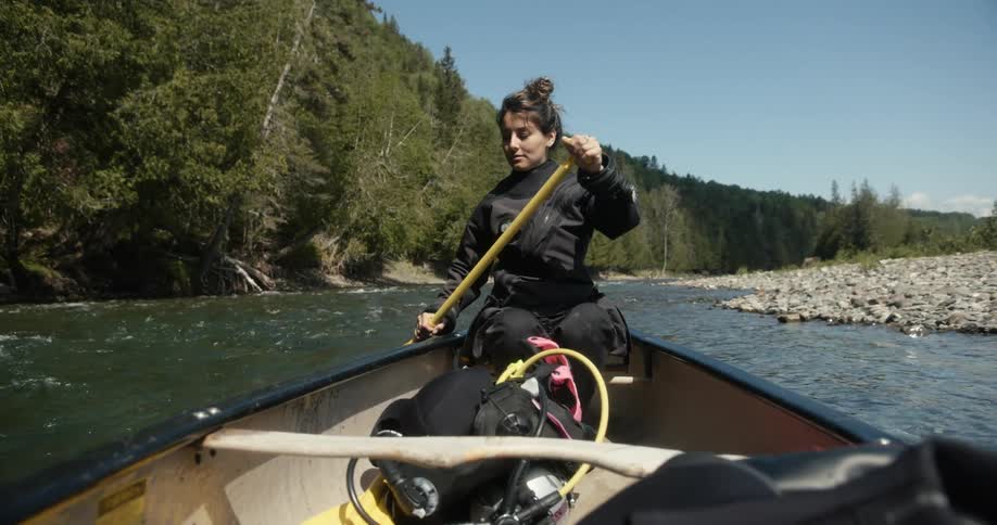 A woman is rowing the boat