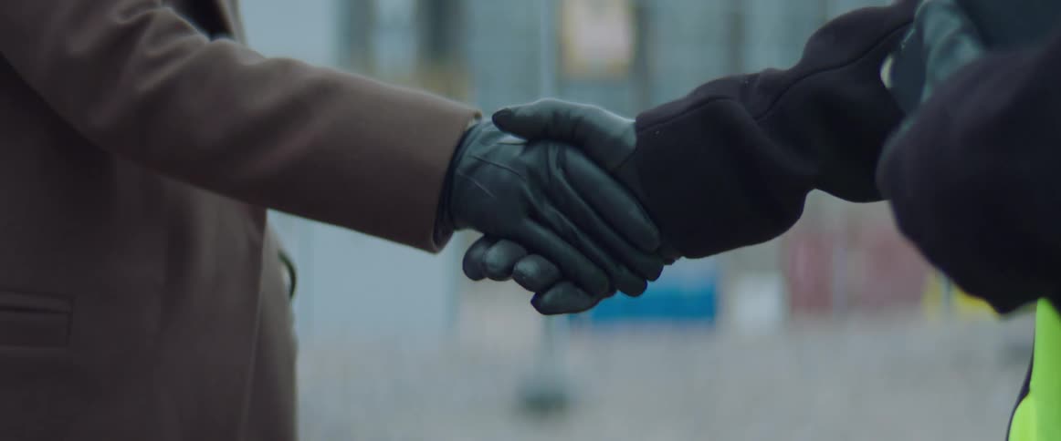 Two people shake hands