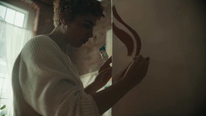 Two painters work on the same canvas