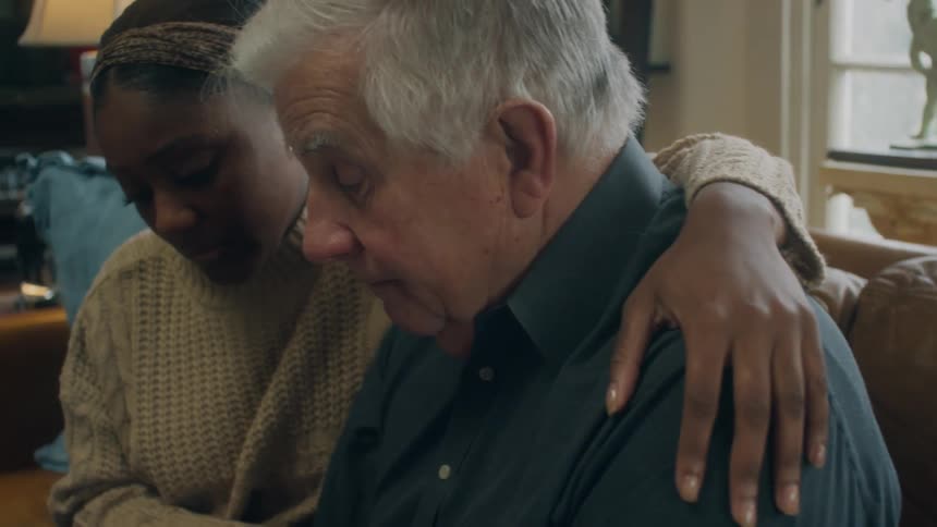 A man and woman sitting inside