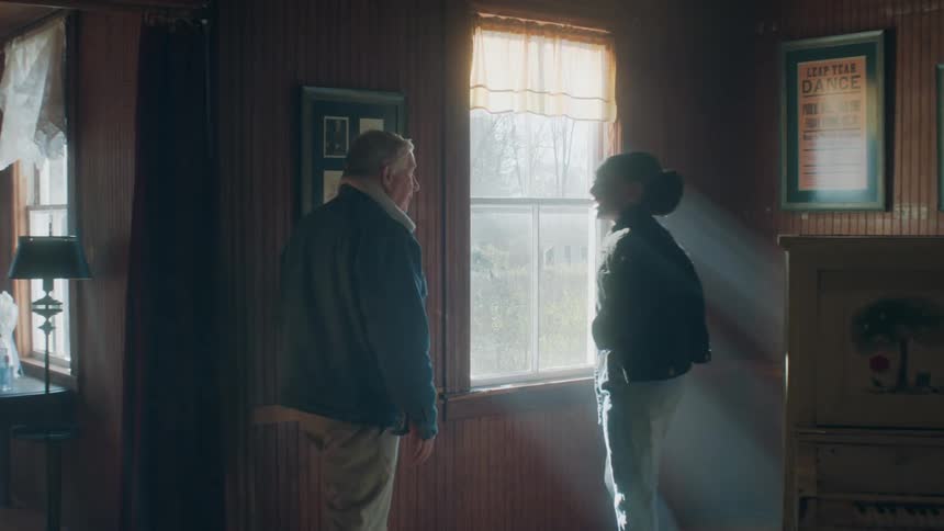 Two people are looking at things on wall