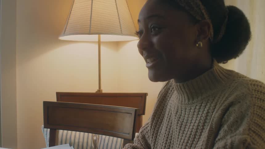 A woman talks at the table